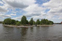 Tervasaari island viewed from the south-east with lush greenery and calm waters