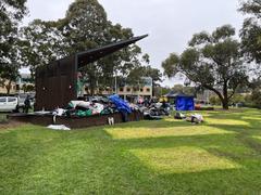 Demolition of camp showing machinery tearing down structures