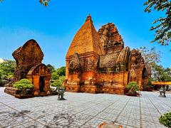 Ancient Cham Hindu temples complex on Mount Cù Lao in Nha Trang, Vietnam with historic brick towers under blue sky
