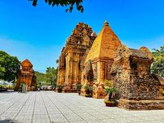 Panoramic view of Po Nagar Cham Hindu temple complex on Mount Cù Lao in Nha Trang, Vietnam with ancient brick towers and green landscape