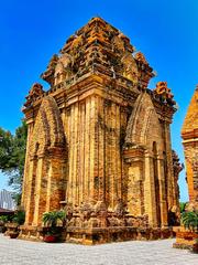 Po Nagar Hindu temple complex in Nha Trang, Vietnam featuring four Tala towers and symmetrical mini temples with a stone statue of Uma inside and a modern Po Nagar goddess replica outside