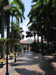 Scenic view of Imbiah Lookout at Sentosa with a tower and lush greenery under a cloudy sky