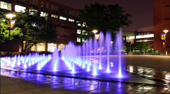 Drexel Fountain with water cascading over painted stone details in a park setting