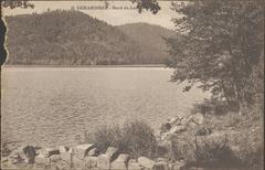Scenic view of Gérardmer Lake from the shore with calm water and surrounding greenery