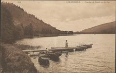 Sunset over Gerardmer Lake with boat dock and peaceful water