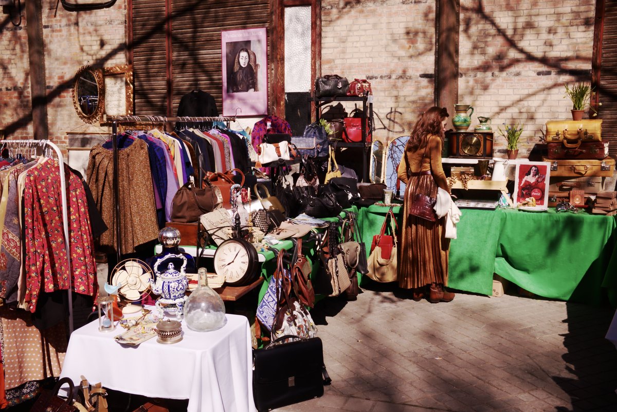Market inside Museo del Ferrocarril in Madrid with various stalls and visitors