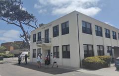 Front facade of the Old Scripps Building in La Jolla facing Pawka Green with Scripps Forum in background