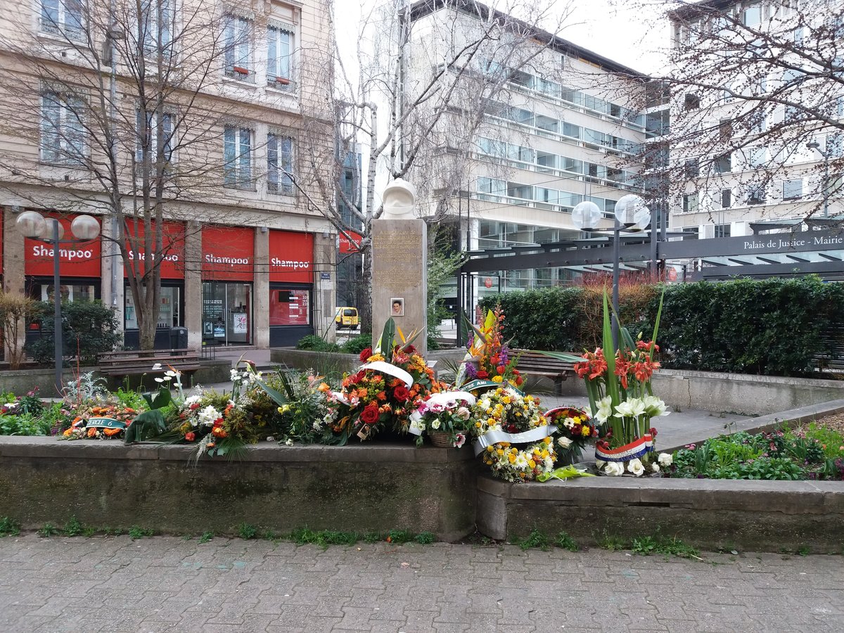 Memorial flowers on Rue Moncey in Lyon 3rd arrondissement in 2020, days after commemoration