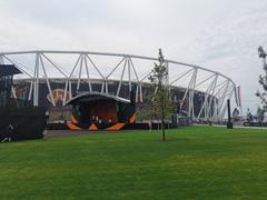 Nemzeti Atlétikai Központ modern athletic center building exterior with people walking outside