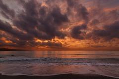 Beach view of Playa de la Misericordia in Spain with calm sea and clear sky