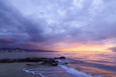 View of Playa de la Misericordia beach with sandy shore and calm sea in Spain