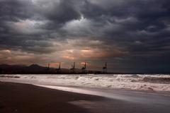 Beach view of Playa de la Misericordia in Spain with sand, umbrellas, and sea