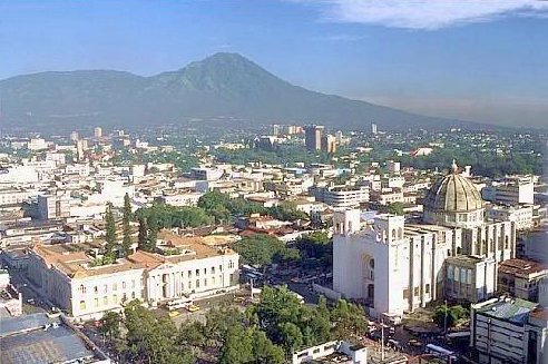 Downtown San Salvador cityscape with modern high-rise buildings under a cloudy sky