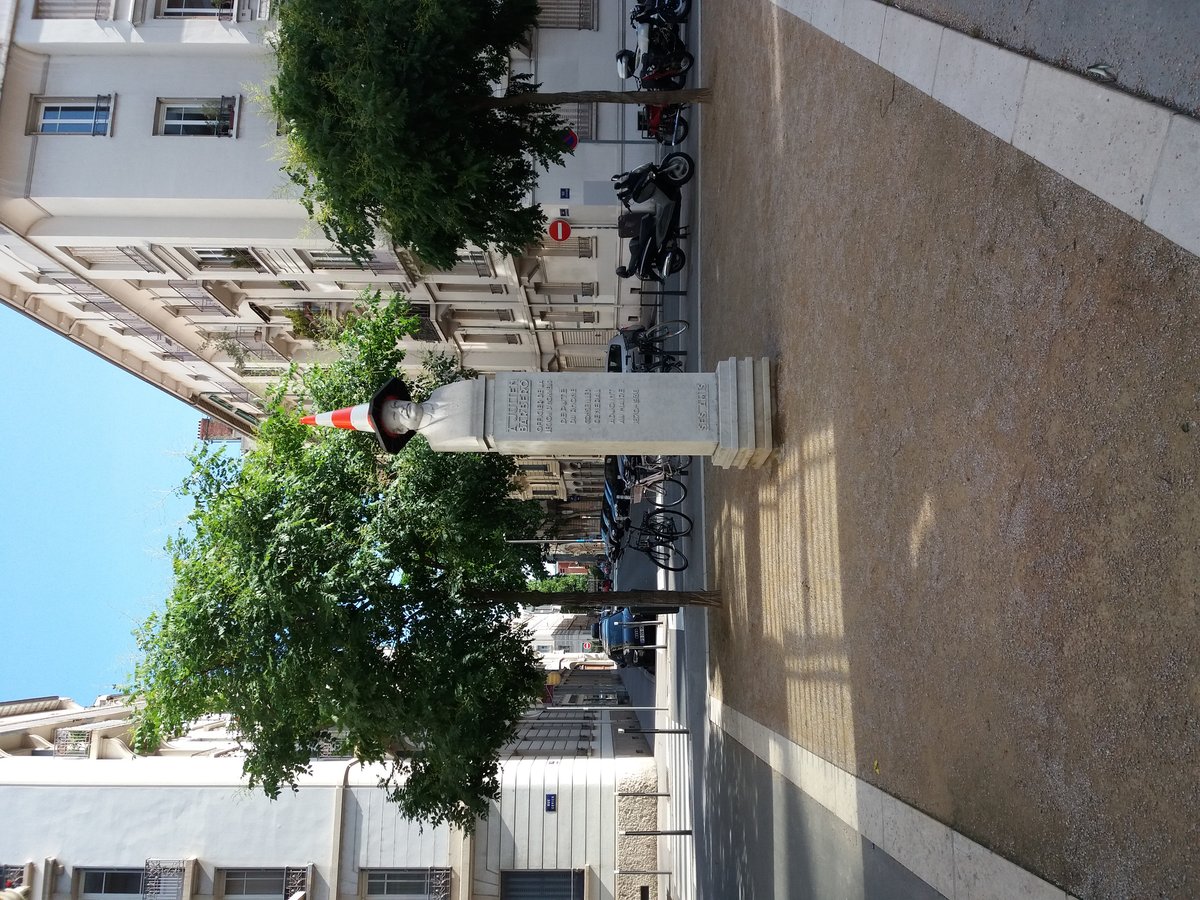 Statue of Julien Barbero on Rue Juliette Récamier in Lyon 6th arrondissement with a traffic cone on its head