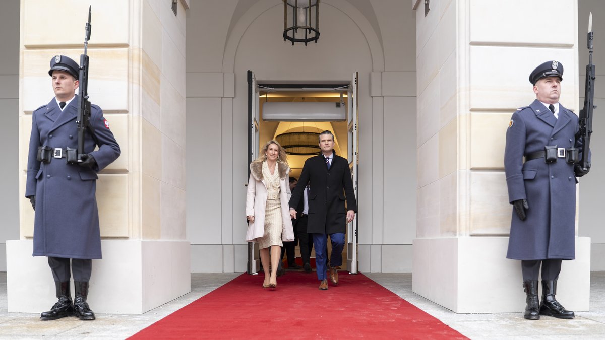 Secretary of Defense Pete Hegseth and spouse Jennifer exiting Polish Presidential Palace after meeting with President Andrzej Duda in Warsaw