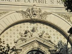 Pediment of the Theater of Porte Saint-Martin in Paris with classical sculptures and inscriptions