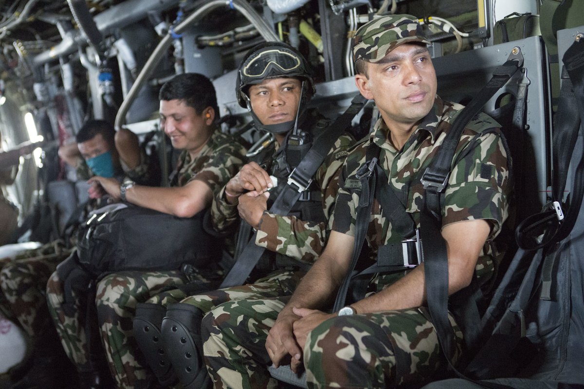 Nepalese service members looking out from a U.S Marine Corps MV-22 Osprey at Tribhuvan International Airport in Kathmandu, Nepal
