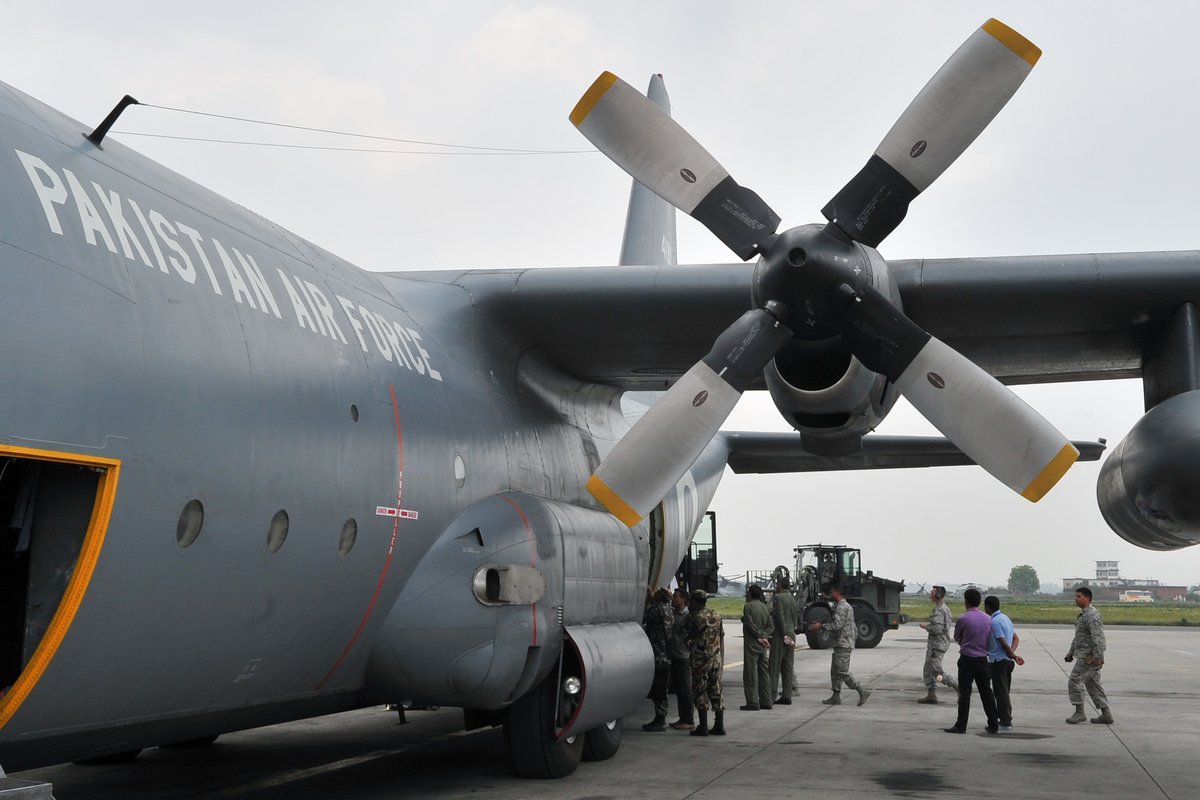 Nepalese Army soldiers and USAF Airmen unloading relief supplies from Pakistan Air Force C-130 Hercules in Kathmandu