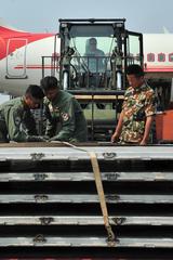 Bangladesh Air Force and Nepalese Army securing aircraft pallets to forklift for disaster relief cargo transfer in Kathmandu Nepal