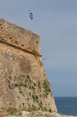 Close-up view of the Greek flag flying over the Fortezza fortress in Rethymno, Crete, Greece