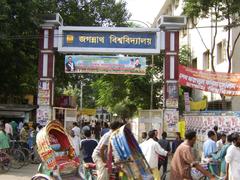 Main entrance of Jagannath University with wide pathway and green surroundings under a blue sky