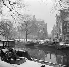 Boats in the Prinsengracht canal with the Noorderkerk church in the background, Amsterdam in winter, 1955