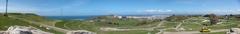 Panoramic view of Parque de Bens in A Coruña, Spain with lush greenery and cityscape under a clear sky
