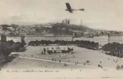 Aerial view of Place Bellecour in Lyon with an airplane flying overhead and Fourvière hill in the background
