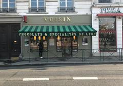 Boutique Voisin storefront in Lyon during May 2018 with window displays and signage