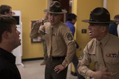 Marine Corps drill instructors correcting a recruit during receiving at Marine Corps Recruit Depot San Diego