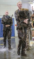Recruits of Lima Company carrying packs after 25-meter swim during Water Survival Basic Qualification at Marine Corps Recruit Depot San Diego