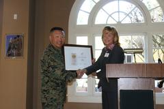 Marine Corps Recruit Depot San Diego Commanding General Brig. Gen. Daniel D. Yoo receiving first Marine Corps museum re-certification from Lin Ezell, National Museum of the Marine Corps director, aboard MCRD San Diego's Command Museum