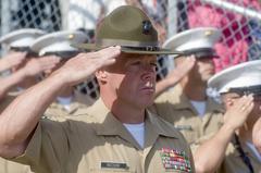 Marines saluting during the national anthem at Marine Corp Recruit Depot graduation ceremony in San Diego