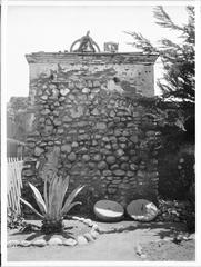 Historic bell tower at San Diego Mission with rope hanging from bell, ca.1905