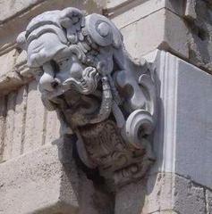 Detail of Porta Grazia, an ornate stone gate with classical architectural elements and sculptures