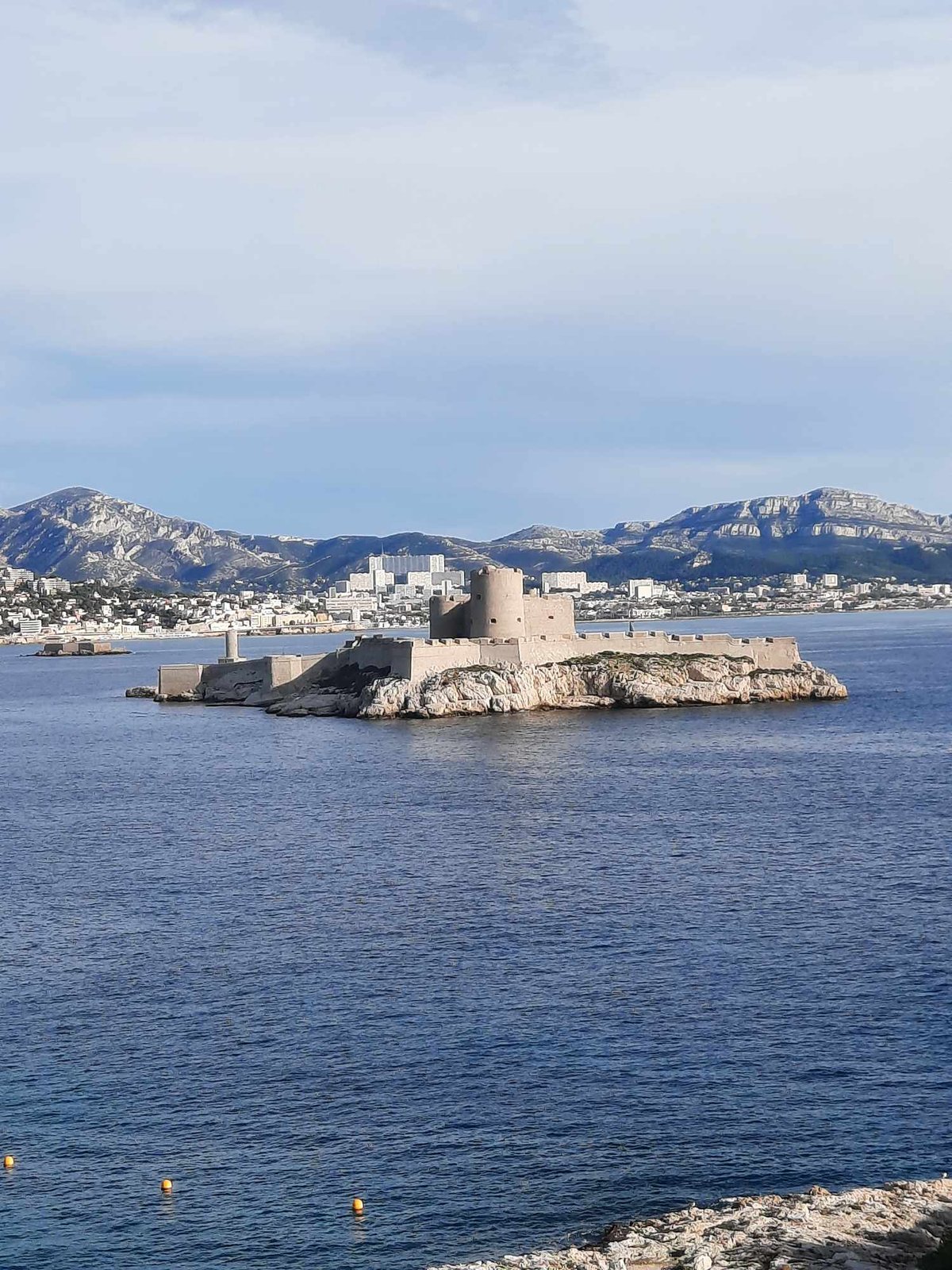 Aerial view of Marseille cityscape with buildings and sea in the background