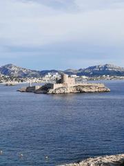Aerial view of Marseille cityscape with buildings and sea in the background