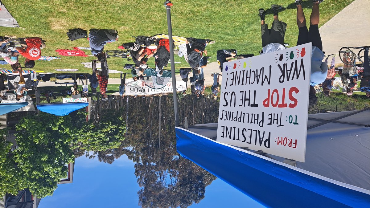 Protest banner reading 'From Palestine to the Philippines, Stop the US War Machine' at Warren Mall, UCSD