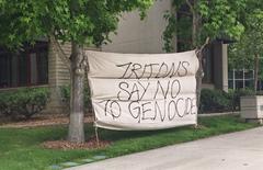 Large protest sign reading 'Tritons say no to genocide' at the Warren Mall, UCSD