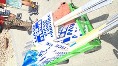 UAW UC strike protestors holding signs in week 3 of strike