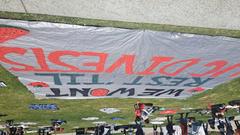 Protest sign at Warren Mall urging USC to divest