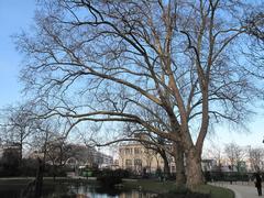 Park of Batignolles with lush greenery and pathways in Paris 17th arrondissement