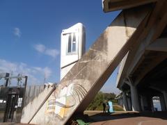 Public outdoor inclined elevator near Han River and Yanghwadaegyo bridge with bicycles and people