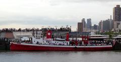 Fireboat docked at Pier 66a under cloudy sky