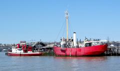 Lightship Frying Pan and fireboat John J. Harvey docked at Pier 66a on a sunny midday looking north