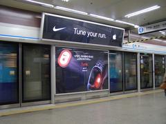 Myeong-dong Station entrance in Seoul with vibrant commercial signs