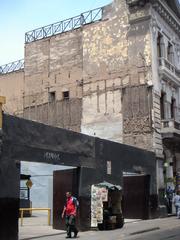 Many parking spaces near old straw and stick constructions in Lima