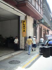 Street scene of a busy parking area in Lima with parked cars and buildings