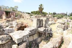 Kerameikos archaeological site with ancient ruins and a pathway under a blue sky