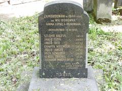 Grave from Borówna with traditional stone markers and a wooden cross